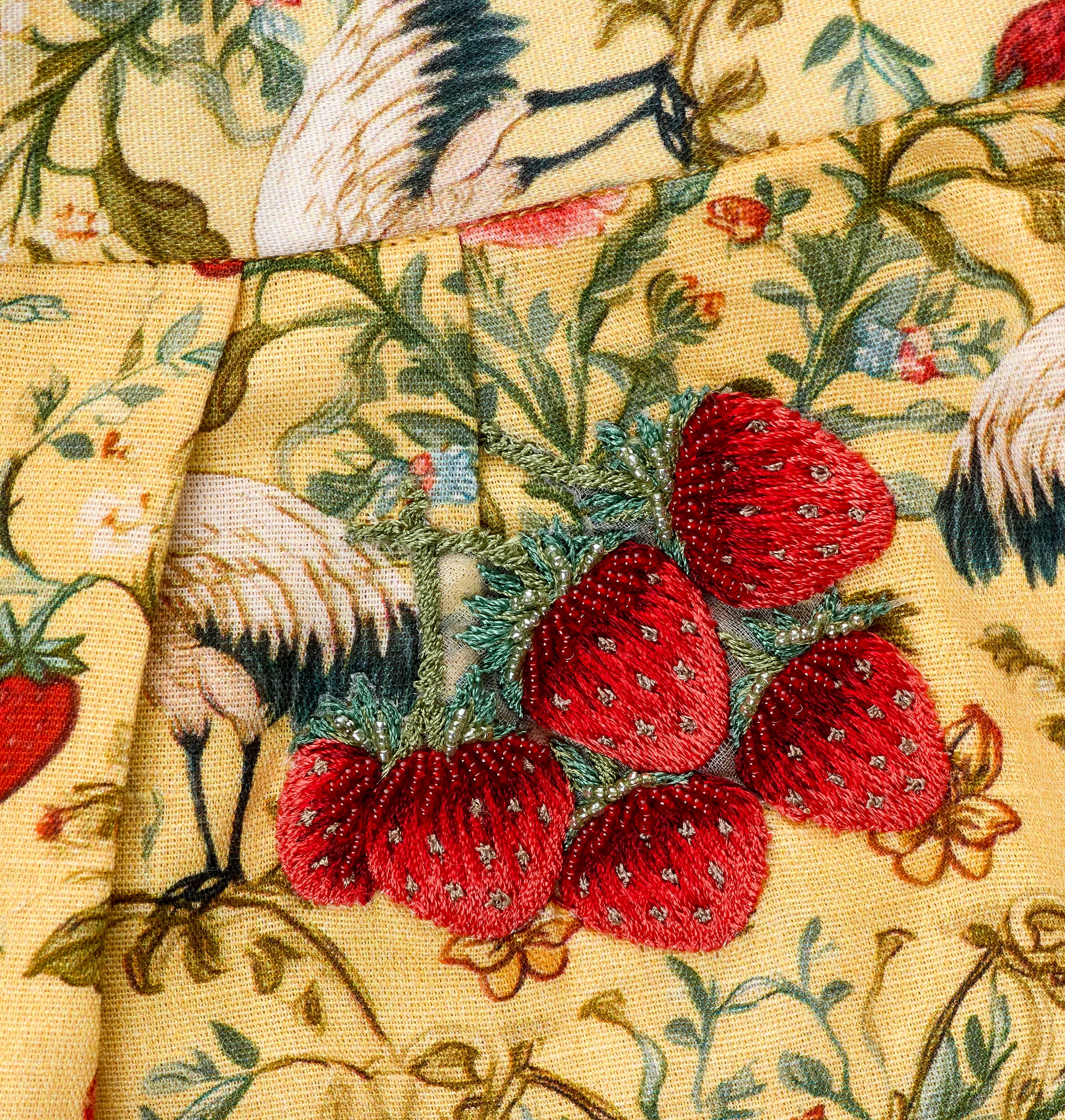 Cyprus girls three-piece set detail — strawberry and butterfly motifs on sheer embroidered cape