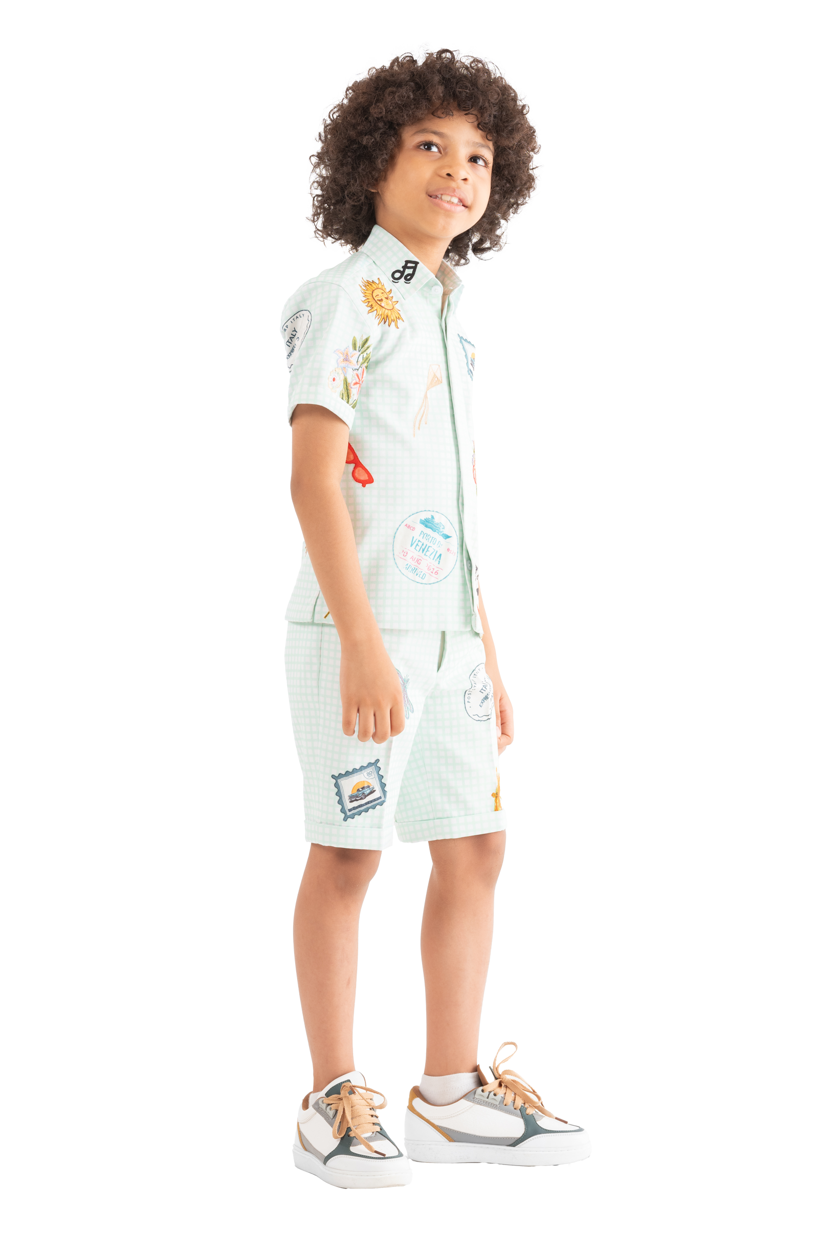 Rhyme Kids - Boy wearing light blue Rhyme by Rupamani twin set with colorful patches and beige sneakers.