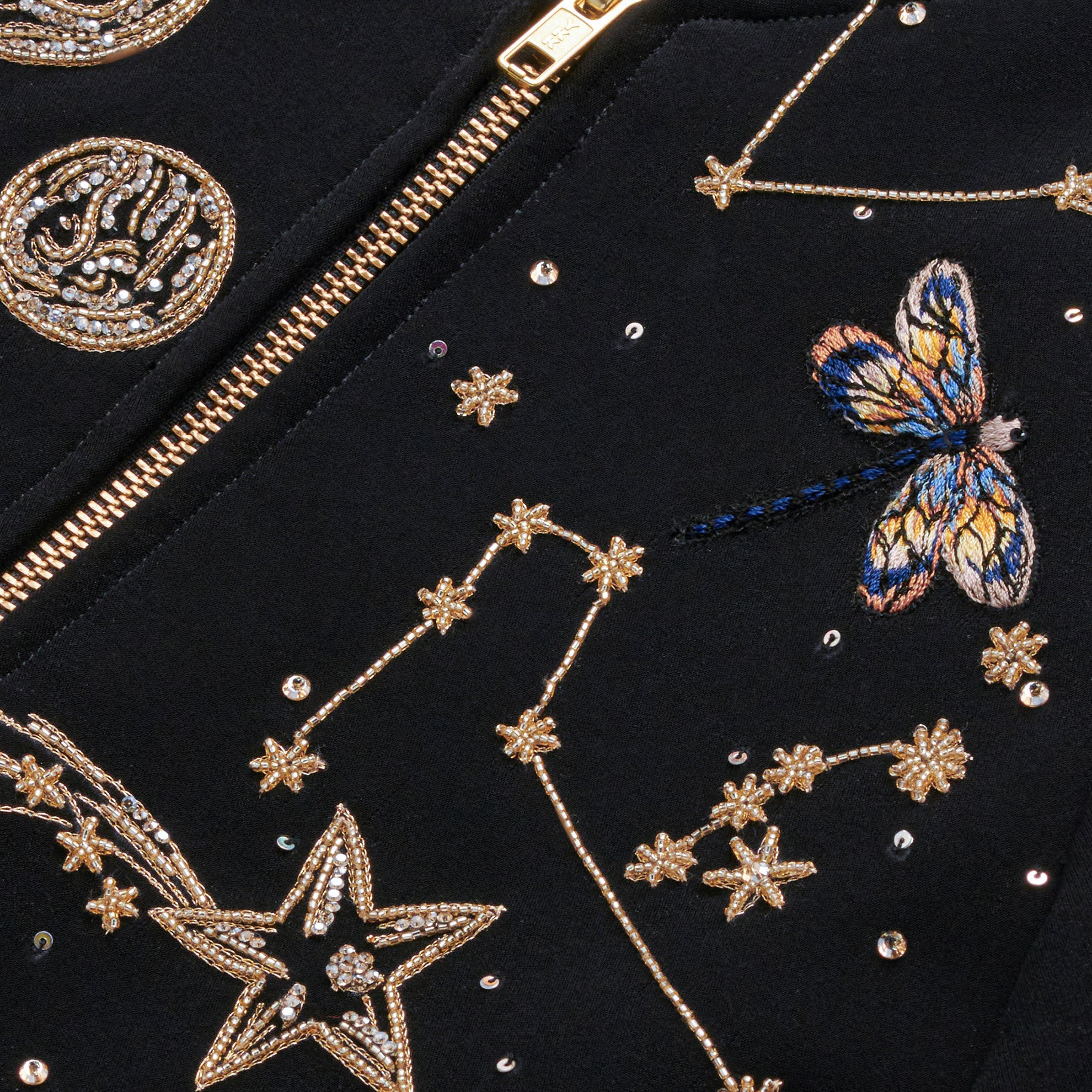 Storm velvet jacket detail — cosmic star and planet hand embroidery with blue dragonfly